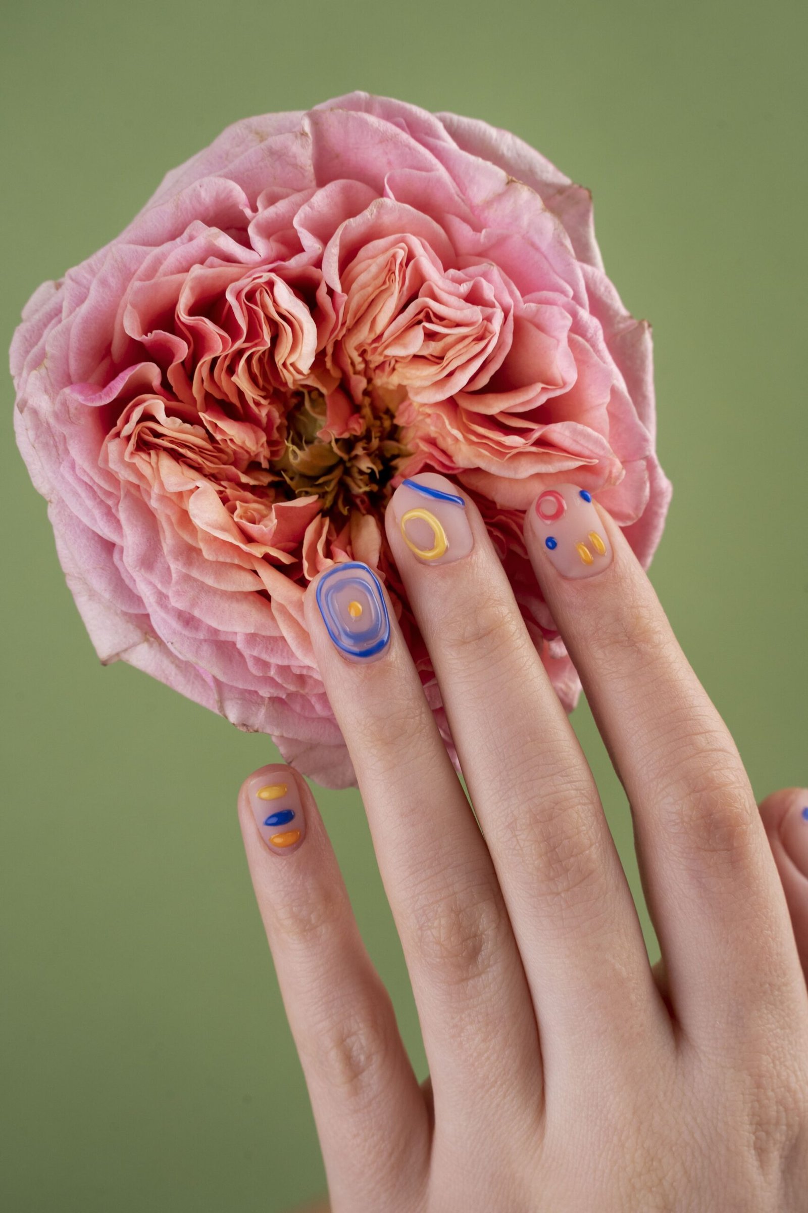 close up hands with beautiful manicure flower 1 scaled